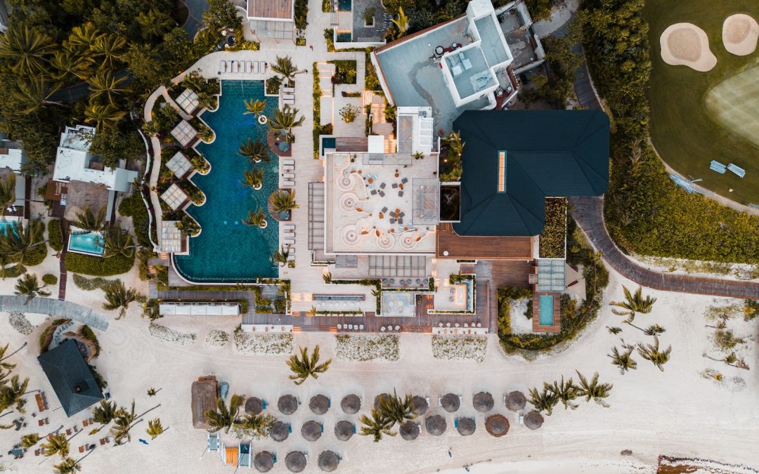 an aerial view of a resort with a swimming pool